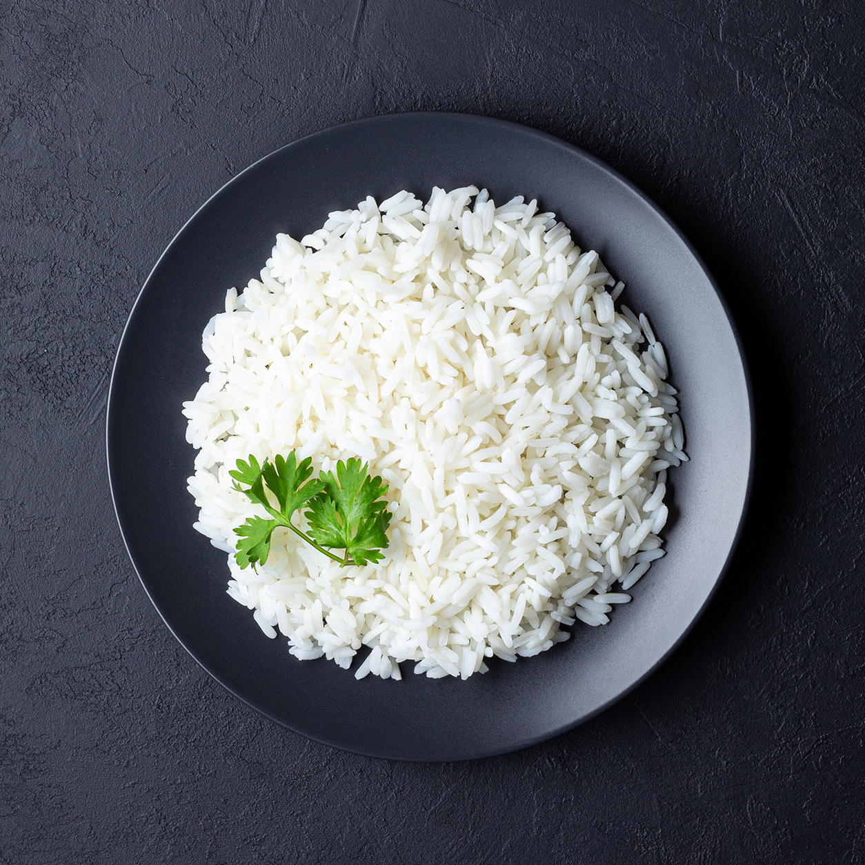 Steamed rice on black plate. Basmati Rice